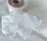 40mm white and iridescent metallic mesh and stripe ribbon with wire edge, shimmering mother‑of‑pearl lurex, ideal for gift wrapping, floral arrangements and decorative crafts.