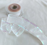 40mm white and iridescent metallic mesh and stripe ribbon with wire edge, shimmering mother‑of‑pearl lurex, ideal for gift wrapping, floral arrangements and decorative crafts.