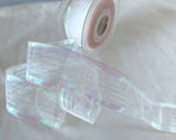 Side view of 40mm wired iridescent stripe‑sheer ribbon on a 20‑metre Berisfords roll.