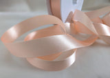 7mm width peach double face satin ribbon. sold by the metre or big discounts for longer lengths and full rolls. Ribbonmoon sewing supplies uk