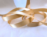 mm width satin ribbon by Berisfords Ribbons in the UK.  Sold by the metre with discounts for longer lengths and full rolls. Honey gold col.678
