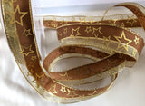 Brown and metallic gold mesh ribbon with wired borders and a gold star  print. 1"-inch width.