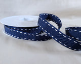 15mm navy polyester grosgrain ribbon with white satin stitch borders. UK manufactured by Berisfords Ribbons. buy online per metre with discount for full 15 metre reels.