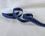 15mm navy polyester grosgrain ribbon with white satin stitch borders. UK manufactured by Berisfords Ribbons. buy online per metre with discount for full 15 metre reels.