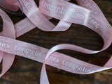 Pale pink 25mm satin ribbon with printed 'Congratulations' text 