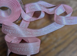 Pale pink 25mm satin ribbon with printed 'Congratulations' text 