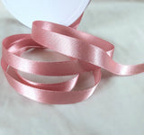 10mm width satin ribbon by Berisfords Ribbons in the UK.  Sold by the metre with discounts for longer lengths and full rolls. Dusky pink, colour 60.
