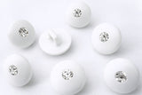 11mm white glossy domed shank button with diamante centre jewel.