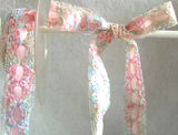 R0481 19mm Multi Coloured Eyelet Lace over a Rose Pink Acetate Ribbon
